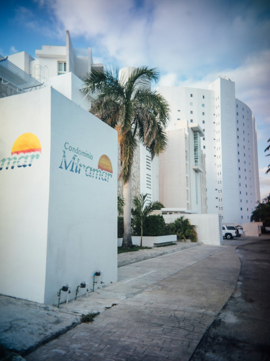 Condominio Miramar sign in front of a modern apartment building.